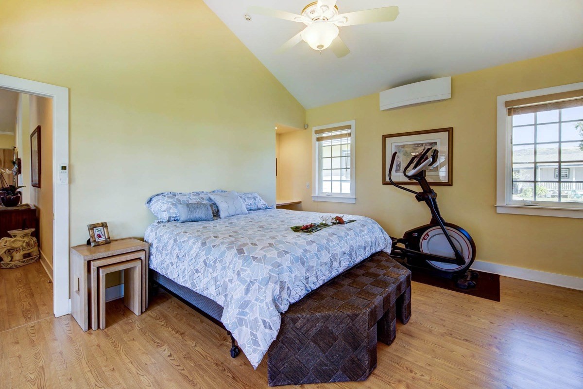 4526 Alae Road, Unit A Kekaha, HI 96752 - Photo 15 of 26 a bedroom with a bed and wooden floor