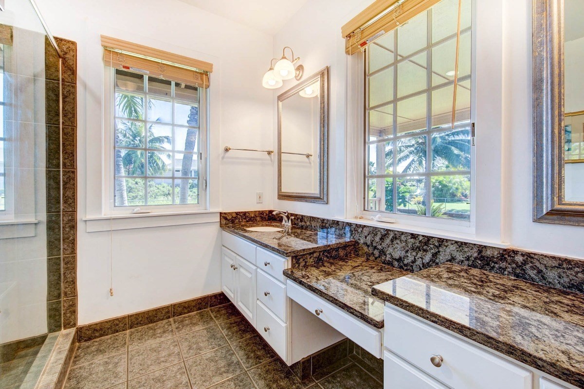 4526 Alae Road, Unit A Kekaha, HI 96752 - Photo 17 of 26 a kitchen with kitchen island granite countertop a stove a sink and a window