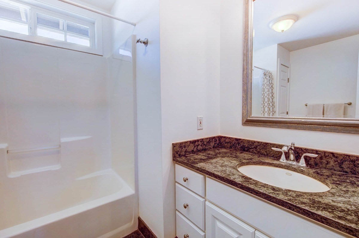 4526 Alae Road, Unit A Kekaha, HI 96752 - Photo 19 of 26 a bathroom with a granite countertop sink and a mirror
