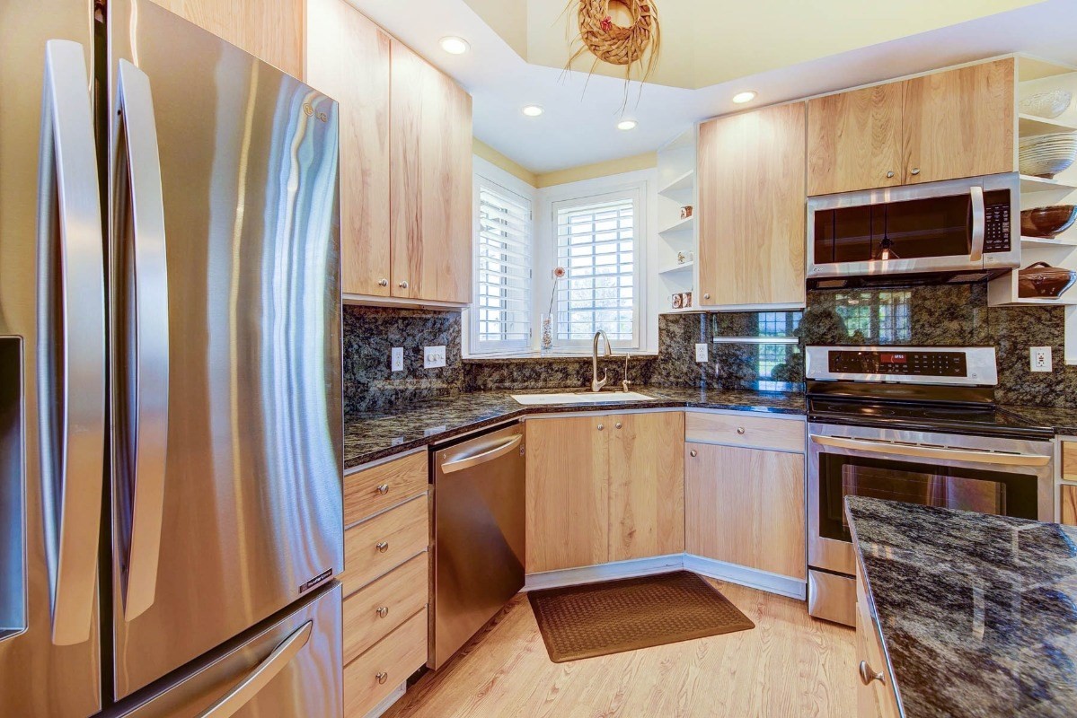 4526 Alae Road, Unit A Kekaha, HI 96752 - Photo 9 of 26 a kitchen with stainless steel appliances granite countertop a refrigerator a stove a sink and a microwave