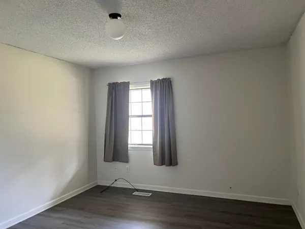a front view of a house with a yard and fence