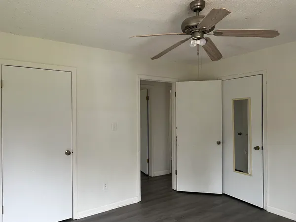 a view of an empty room and wooden floor
