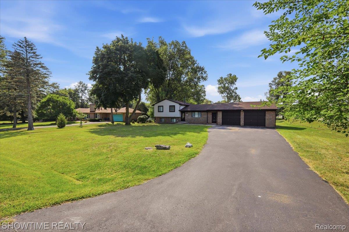 Paved driveway leading to a three-car garage