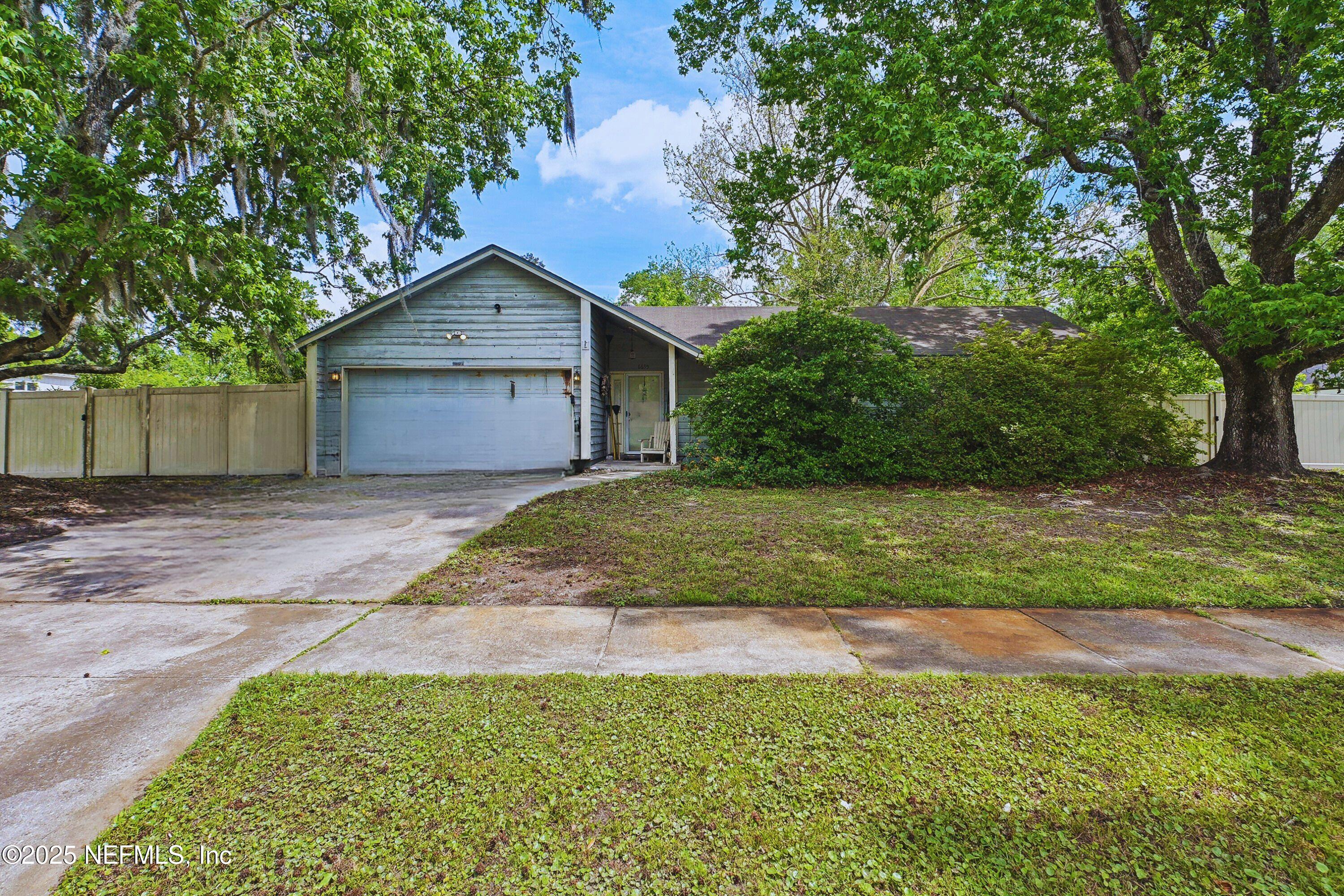 6695 Arrowroot Drive Jacksonville, FL 32244 - Photo 1 of 2 a front view of house with yard and trees