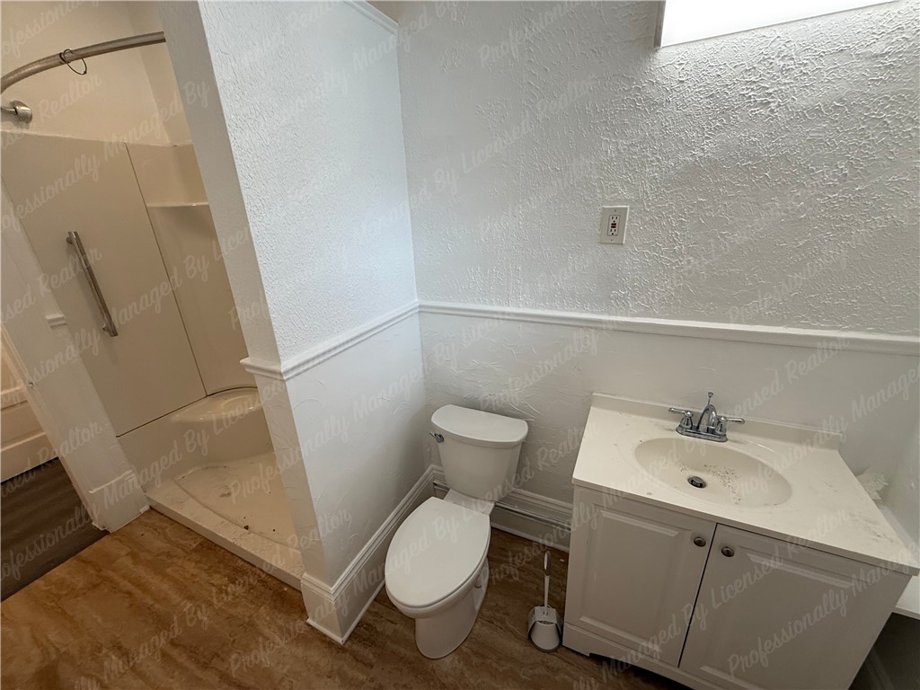 44 West High Street, Unit B Springfield, OH 45502 - Photo 29 of 31 This bathroom features a shower, toilet, and vanity, creating a functional space.