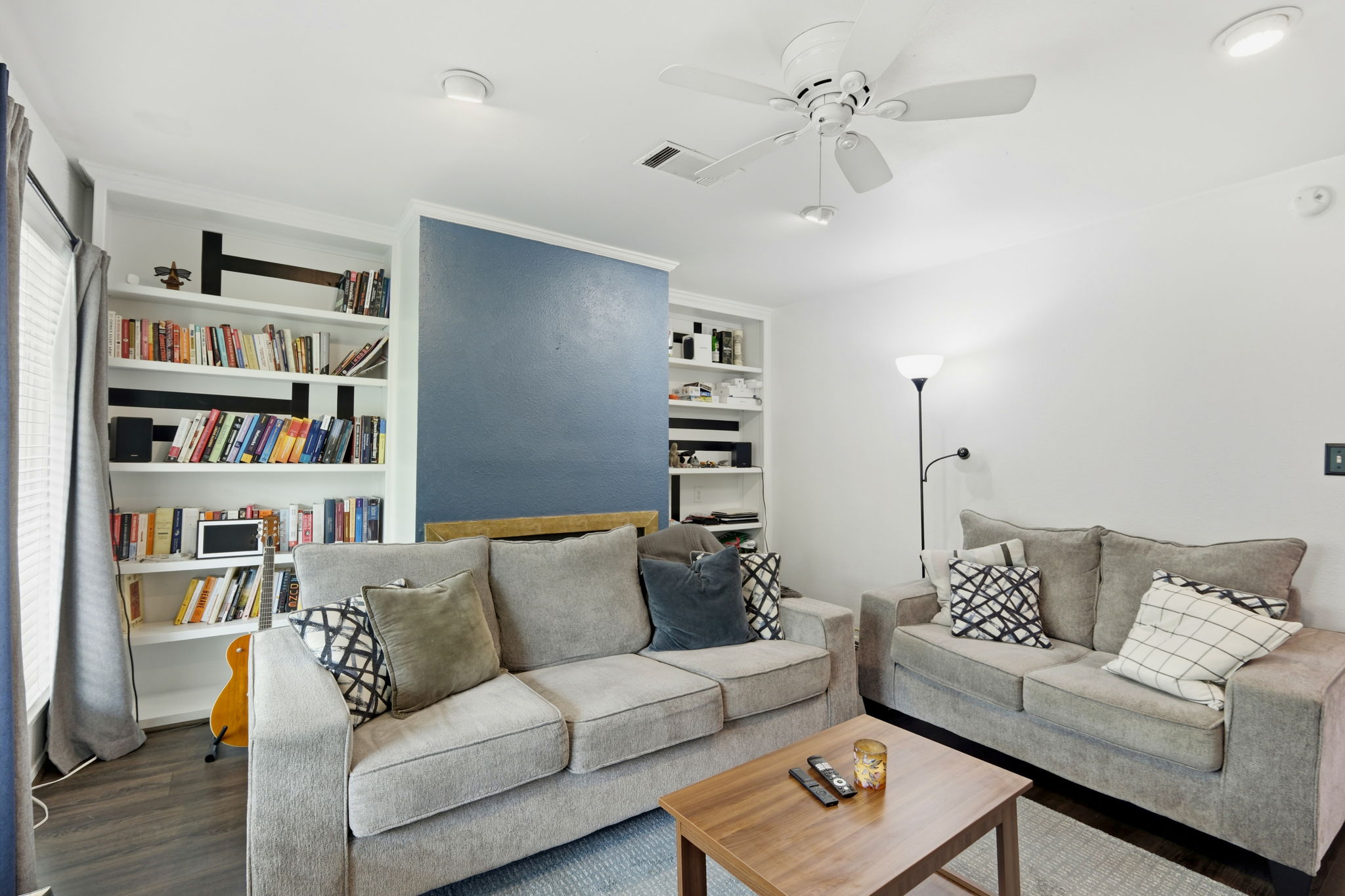6910 Hart Lane, Unit 912 Austin, TX 78731 - Photo 6 of 36 Living area featuring dark wood-finish flooring, white walls, and a ceiling fan