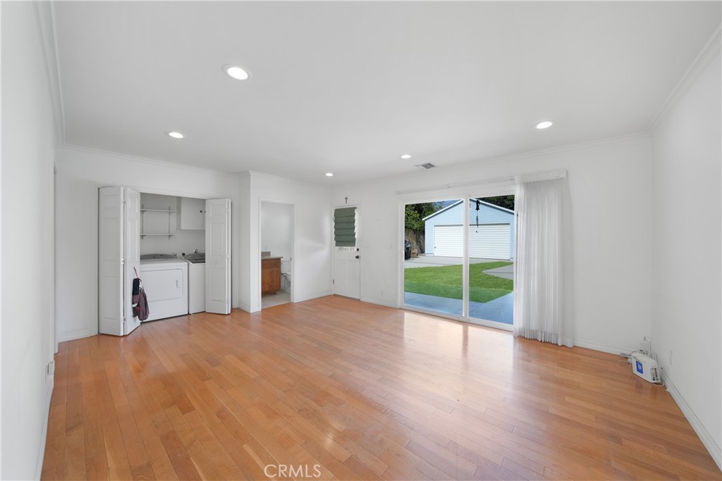 3837 Mountain View Avenue Pasadena, CA 91107 - Photo 16 of 41 a view of an empty room with wooden floor and kitchen space
