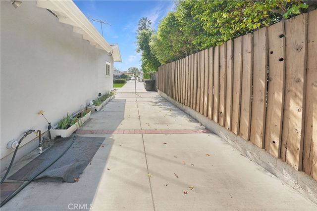 a view of a pathway with a wrought fence