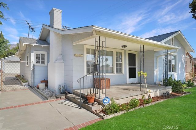 a front view of a house with a yard outdoor seating and garage