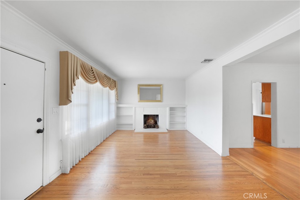 3837 Mountain View Avenue Pasadena, CA 91107 - Photo 7 of 41 a view of a livingroom with wooden floor fireplace and window