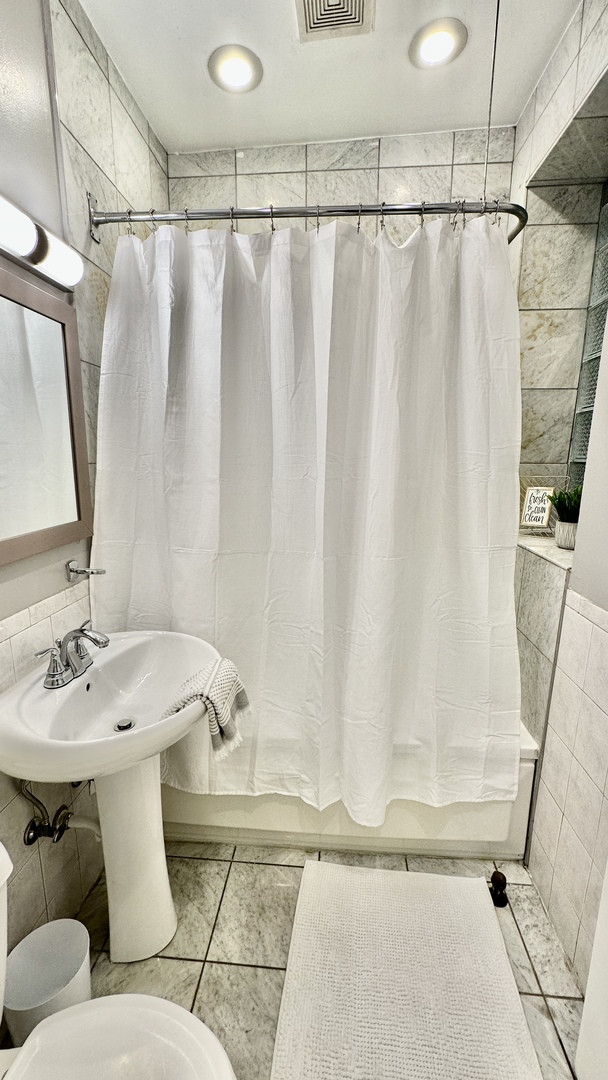 1319 West Addison Street, Unit 1A Chicago, IL 60613 - Photo 17 of 20 a bathroom with a sink and a mirror