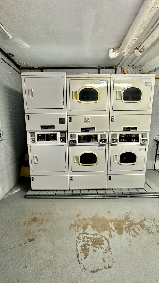 1319 West Addison Street, Unit 1A Chicago, IL 60613 - Photo 18 of 20 a white kitchen with a stove and a microwave