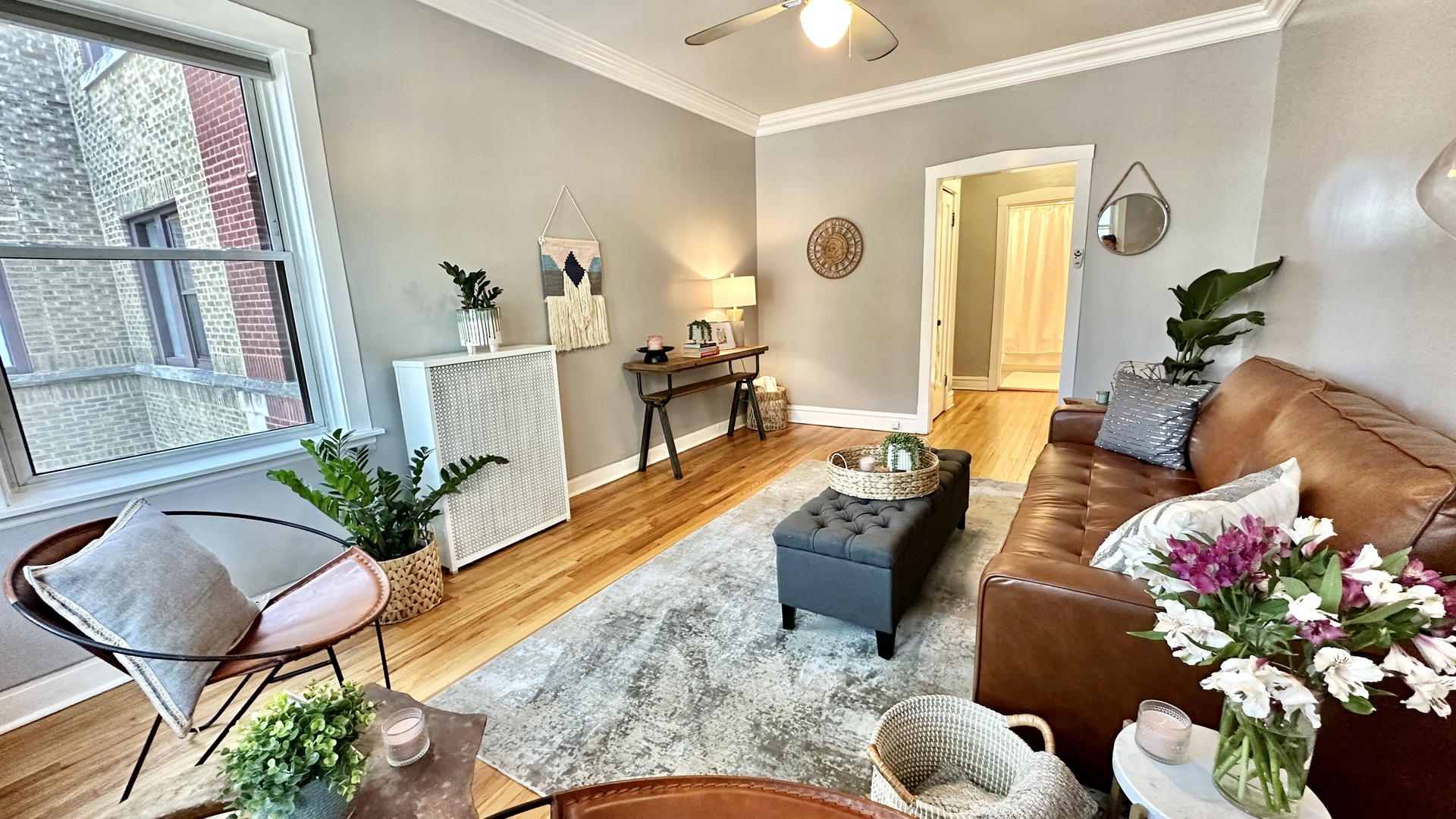 1319 West Addison Street, Unit 1A Chicago, IL 60613 - Photo 3 of 20 a living room with furniture potted plant and a large window