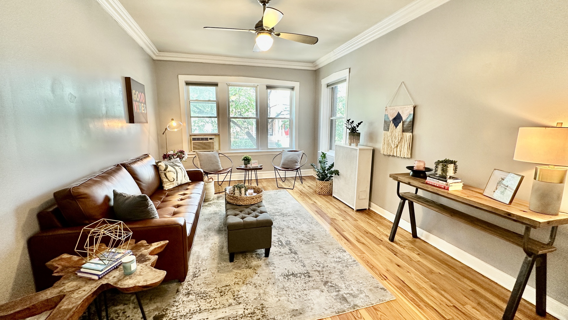 1319 West Addison Street, Unit 1A Chicago, IL 60613 - Photo 4 of 20 a living room with furniture fireplace and a large window