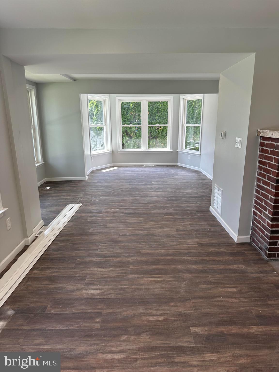 2102 Reading Avenue West Lawn, PA 19609 - Photo 9 of 17 a view of an empty room with wooden floor and a window