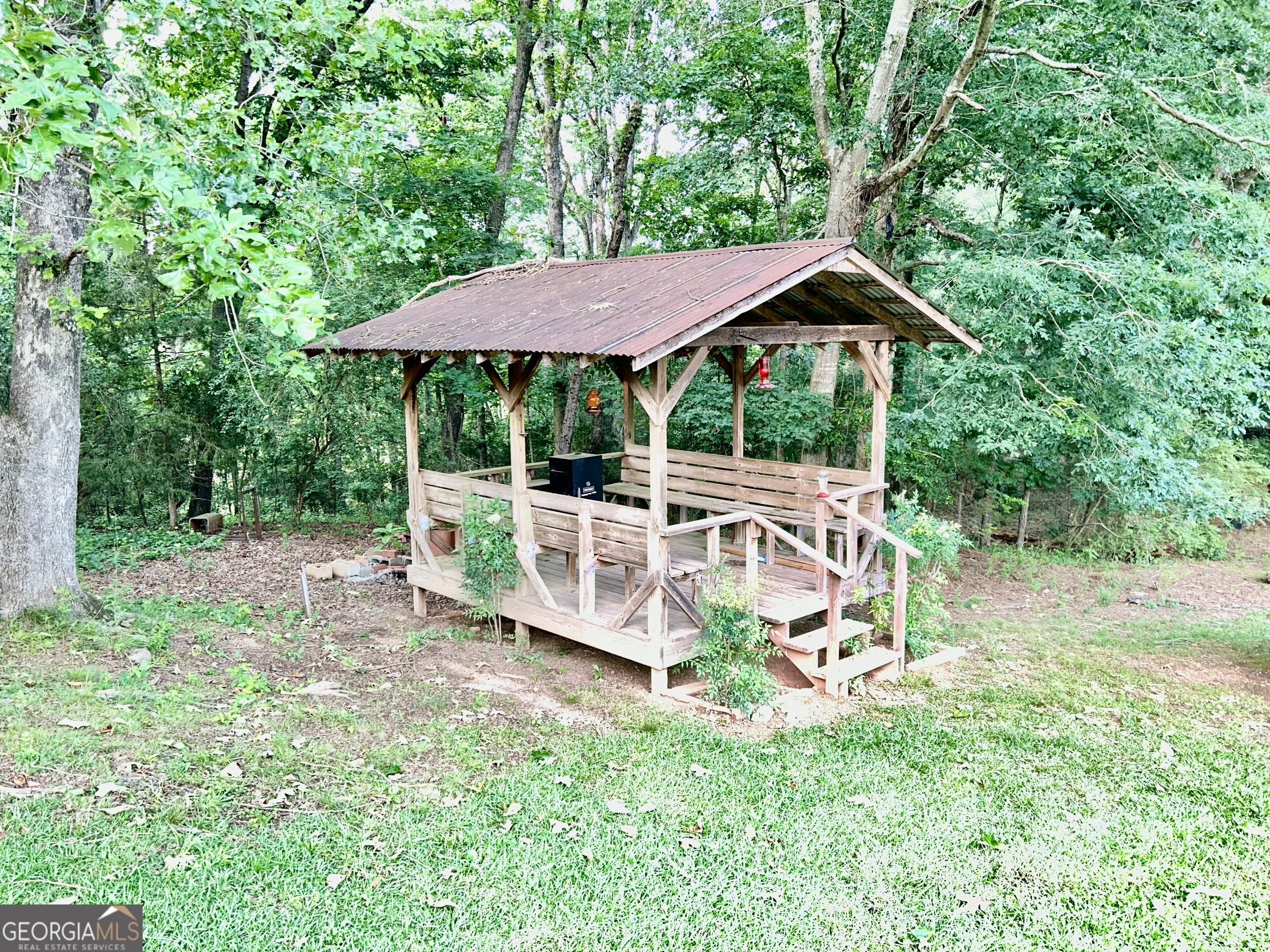 3272 Horace Road Bowman, GA 30624 - Photo 12 of 40 a view of a patio with table and chairs under an umbrella