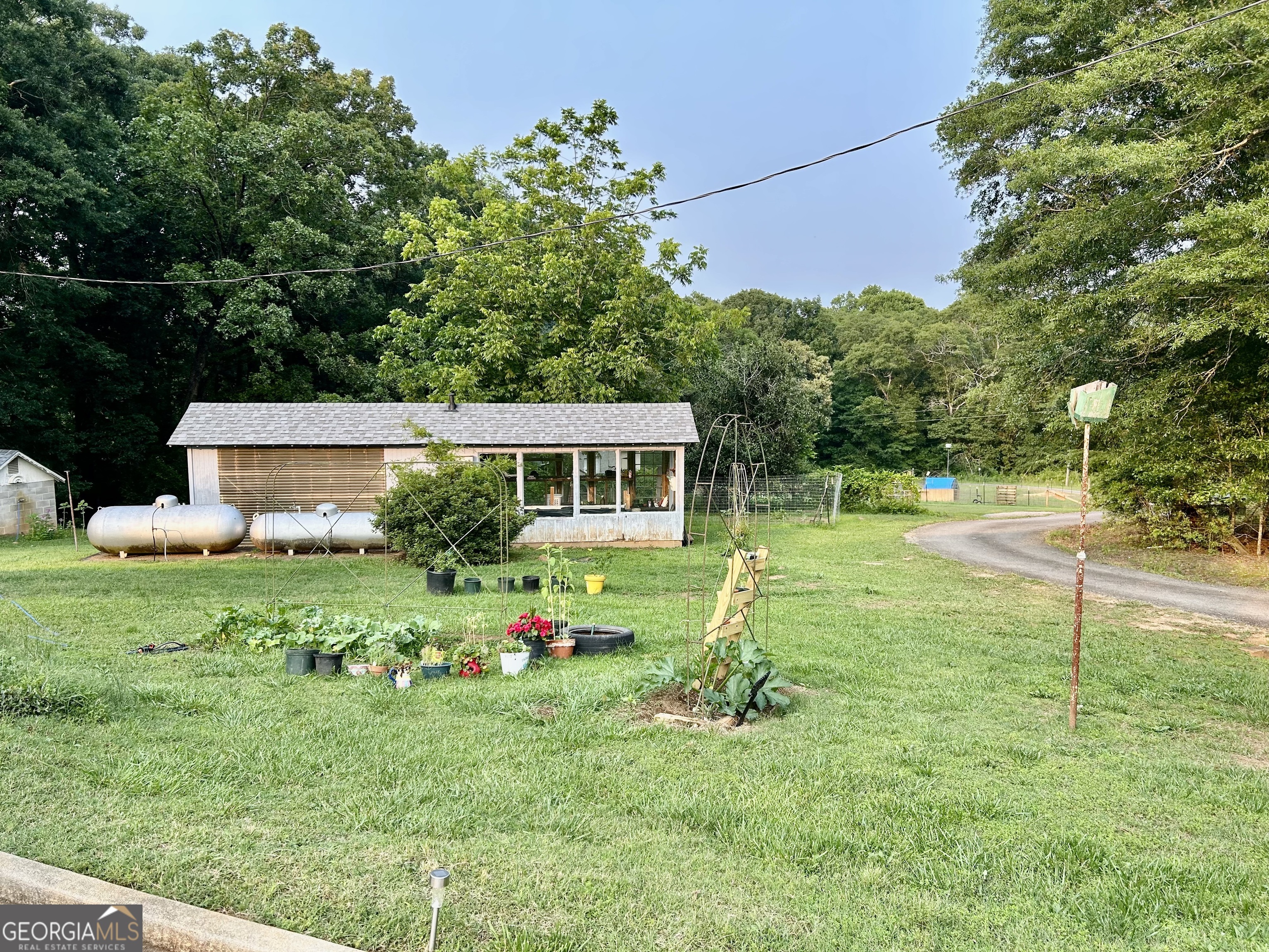 3272 Horace Road Bowman, GA 30624 - Photo 4 of 40 a front view of house with a garden and trees
