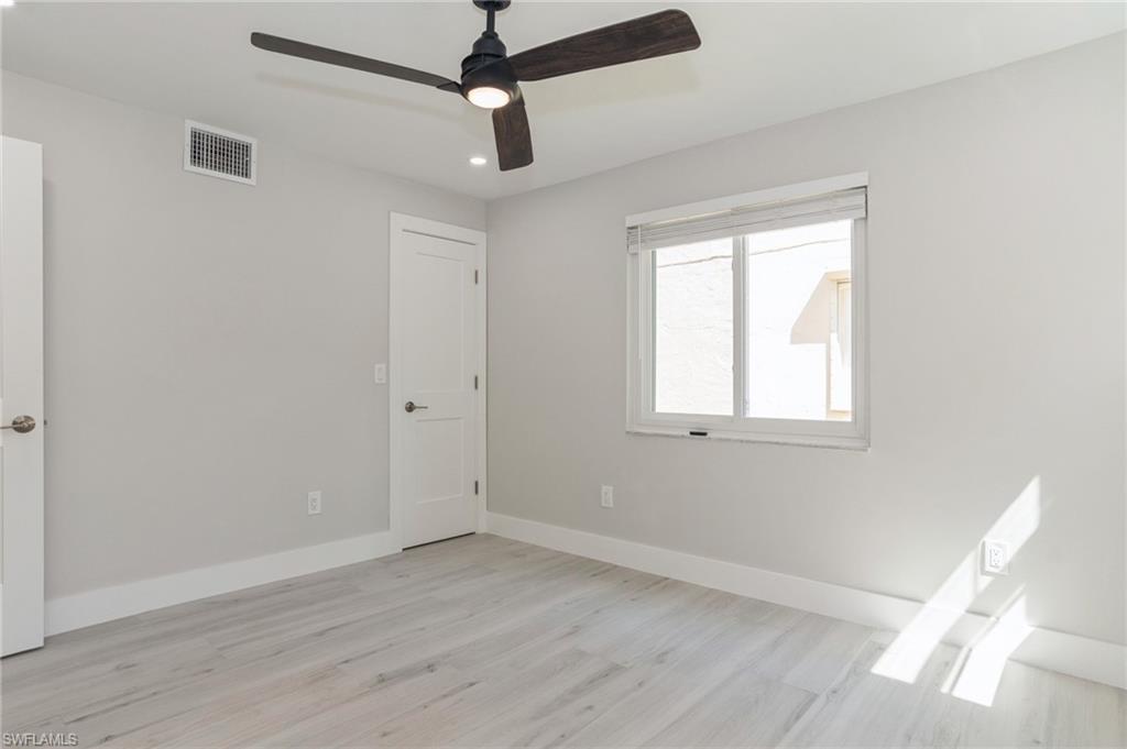 1155 Sandpiper Street, Unit B3 Naples, FL 34102 - Photo 10 of 21 Unfurnished bedroom with a ceiling fan, light wood finished floors, and recessed lighting