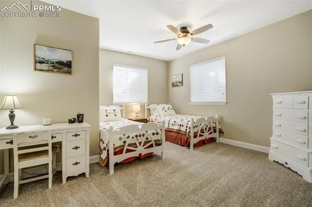 a bedroom with two beds and a lamp