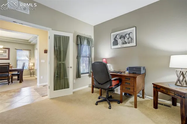 a view of a workspace with furniture and a workspace