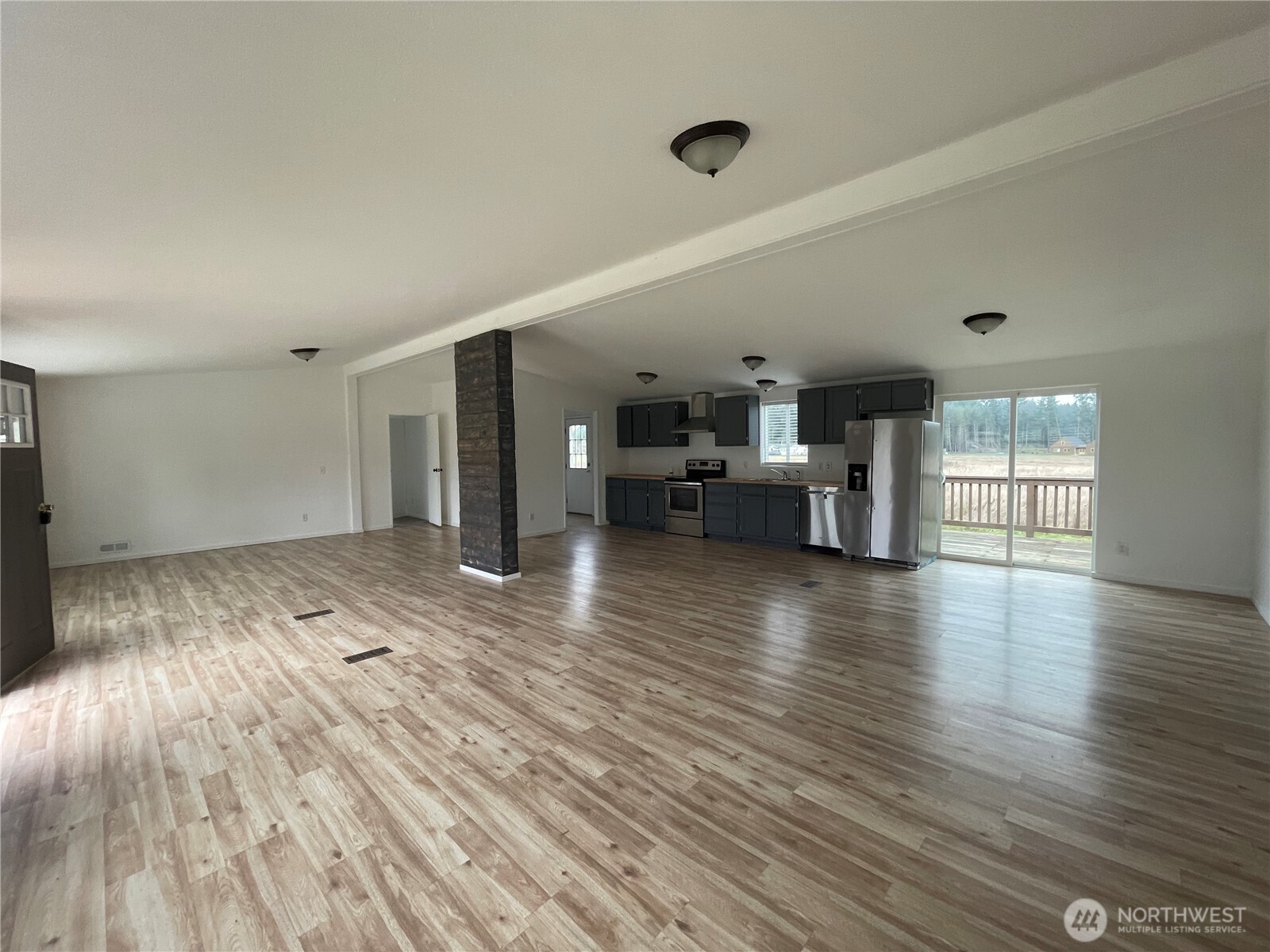 564 West Avery Road Winlock, WA 98596 - Photo 10 of 24 an empty room with wooden floor and windows