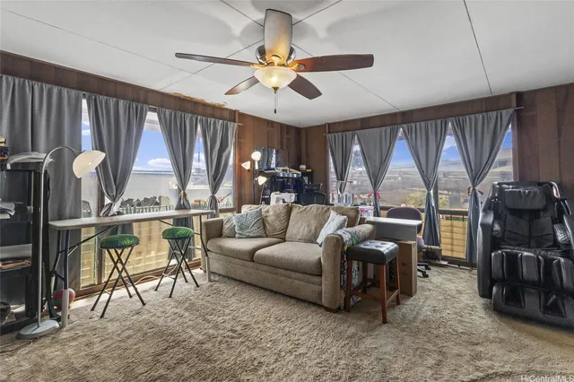 a living room with furniture a large window and a flat screen tv