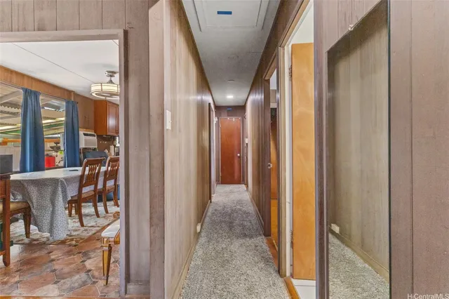 a view of a hallway with windows and stairs