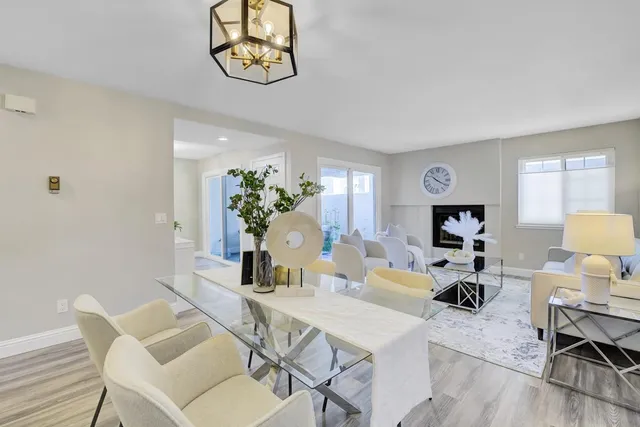 a living room with furniture a dining table and a fireplace