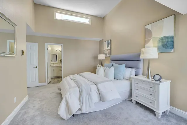 a bedroom with a bed and a night stand