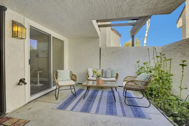 a outdoor space with a couch and chairs