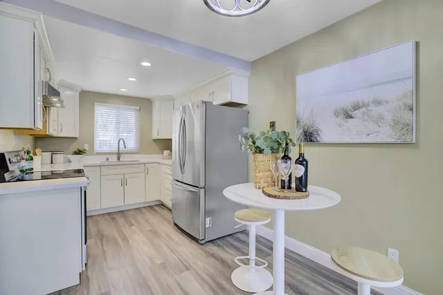 a kitchen with a refrigerator and cabinets
