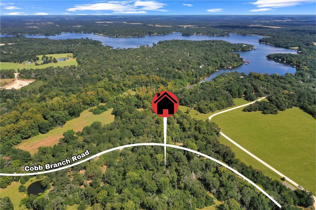 Aerial view of property and surrounding area featuring a large body of water and property boundaries highlighted
