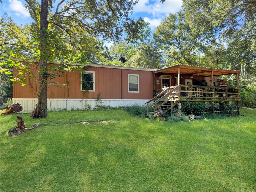 10134 Cobb Branch Road Franklin, TX 77856 - Photo 3 of 23 Rear view of property with stairway, a lawn, and a wooden deck