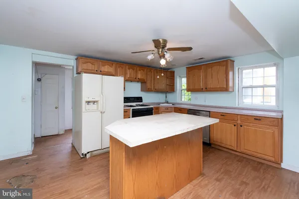a kitchen with stainless steel appliances a refrigerator and a stove top oven