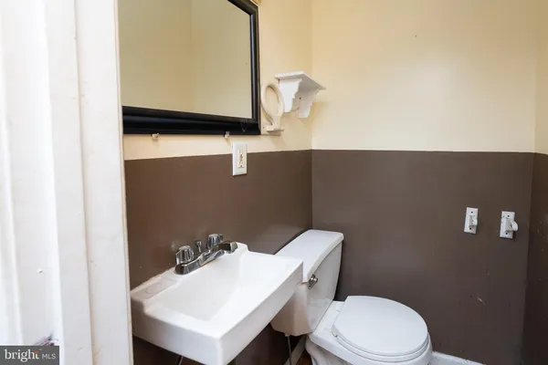 a bathroom with a sink a toilet and mirror
