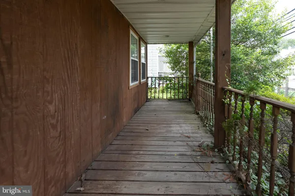 a view of a porch with wooden floor and stairs