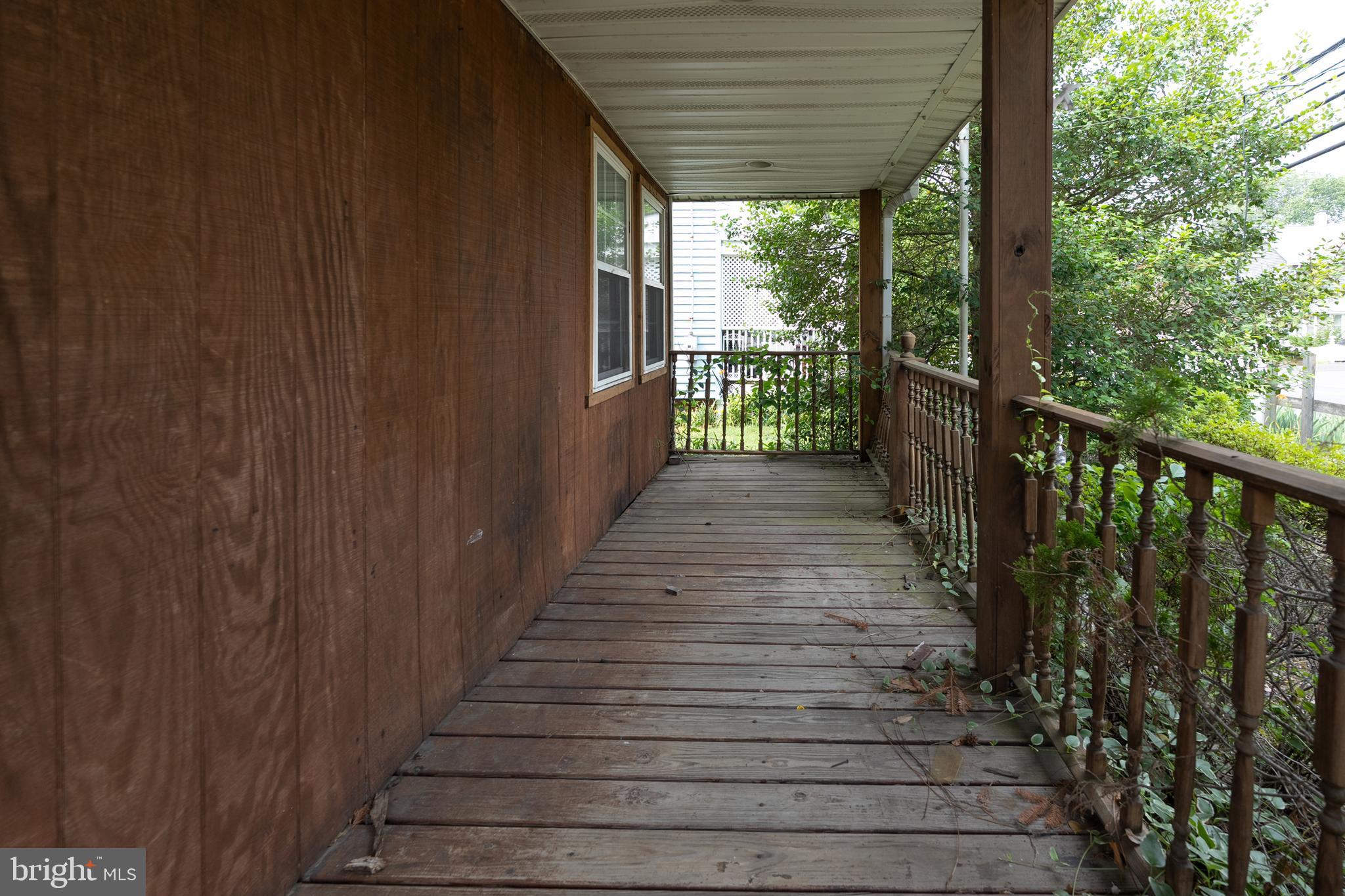 33 Clementon Road West Gibbsboro, NJ 08026 - Photo 7 of 47 a view of a porch with wooden floor and stairs