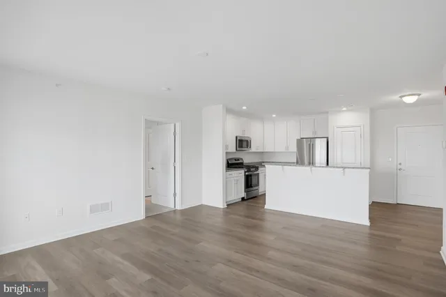 a view of a kitchen with microwave and cabinets