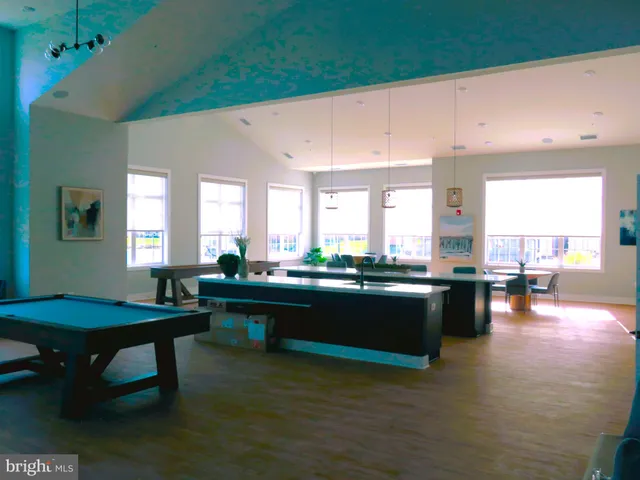 a living room with furniture a flat screen tv and a window