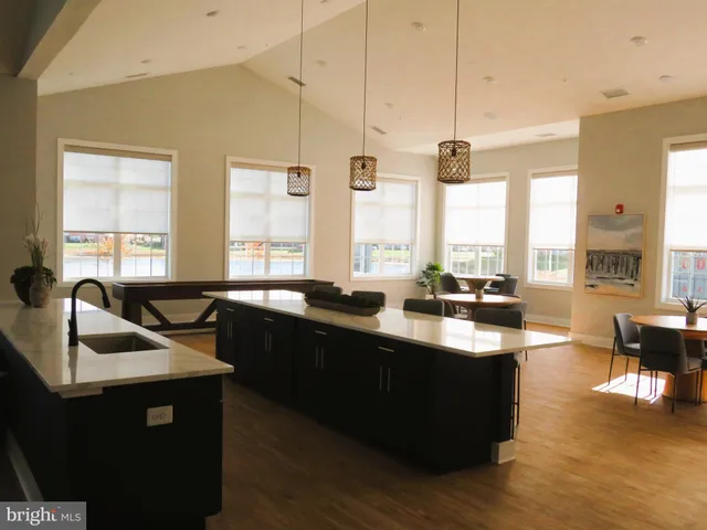 a living room with furniture a fireplace and windows