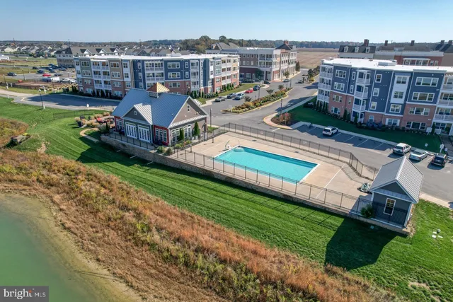 an aerial view of a house with a garden and lake view