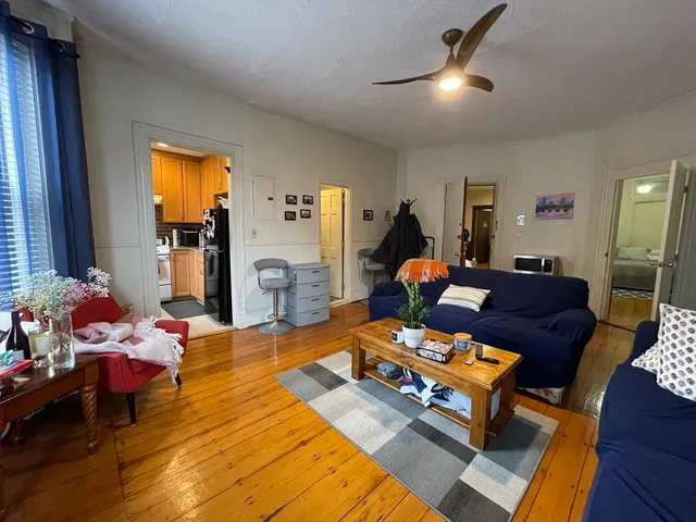 a living room with furniture and a dining table