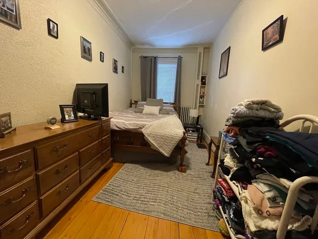 a bed room with a bed and a television