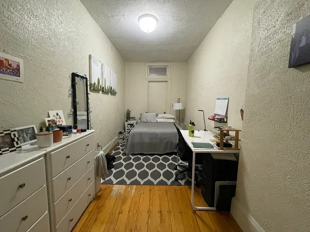 a bed room with a bed and a dresser