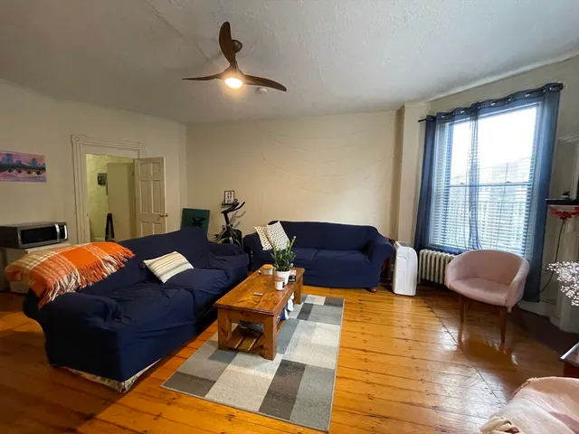 a living room with furniture and a rug