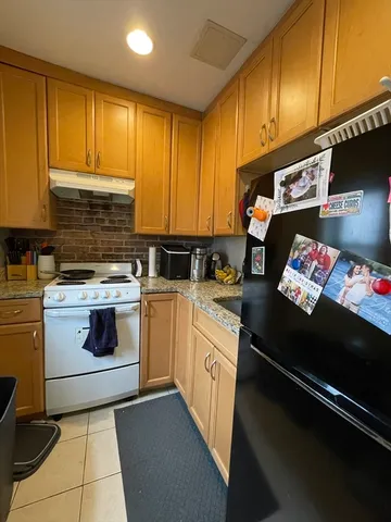 a kitchen with stainless steel appliances a stove a sink and cabinets