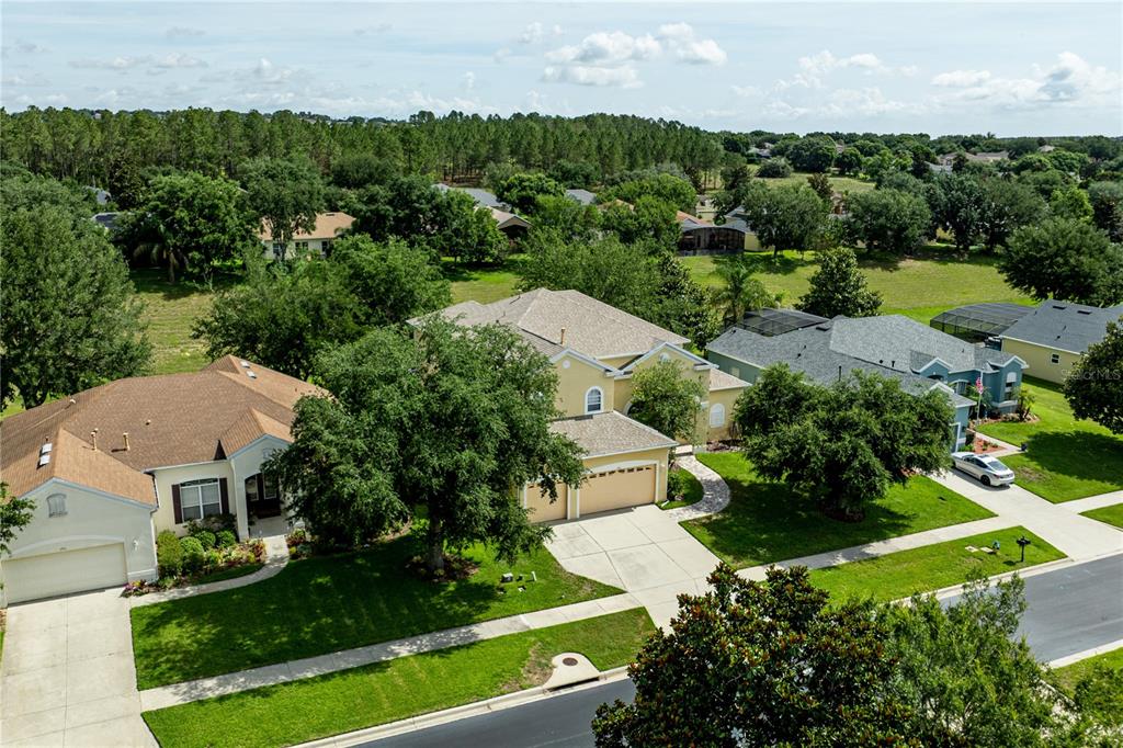 2718 Knightsbridge Road Clermont, FL 34711 - Photo 65 of 72 an aerial view of a house with garden space and street view