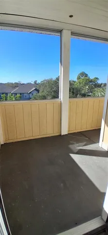 a view of balcony with furniture and a window