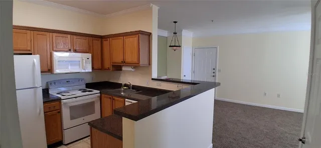 a kitchen that has a sink and a stove in it