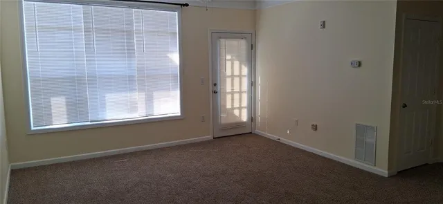 a view of an empty room with a window